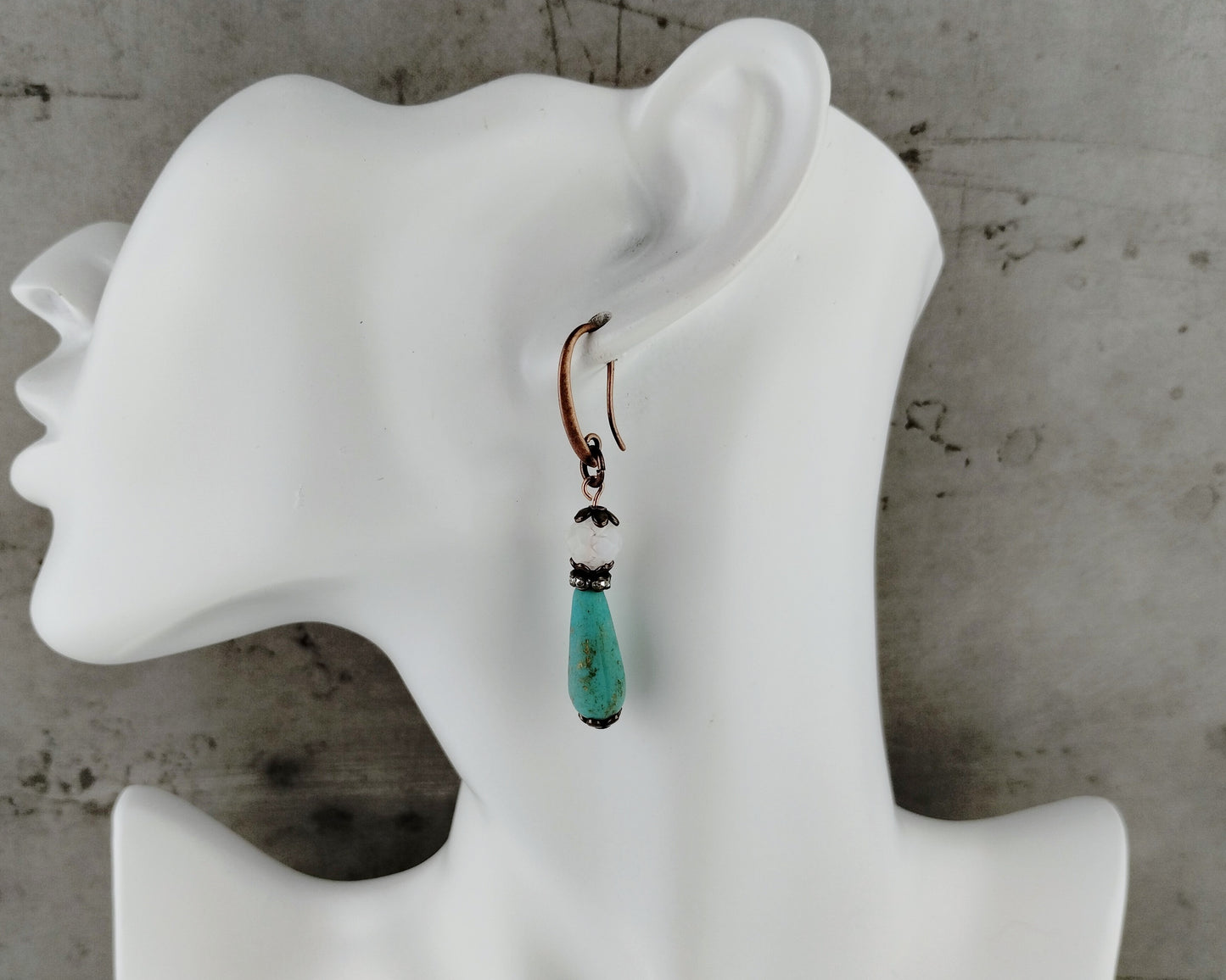 Frosted white and blue beaded earrings with copper accents.