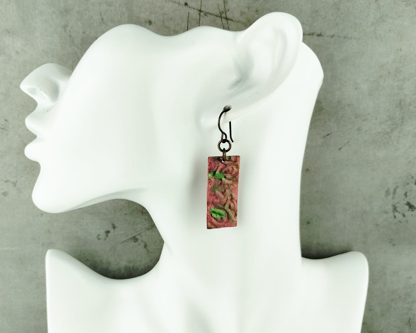 Close-up of embossed floral earrings with nickel-free brass French hooks.