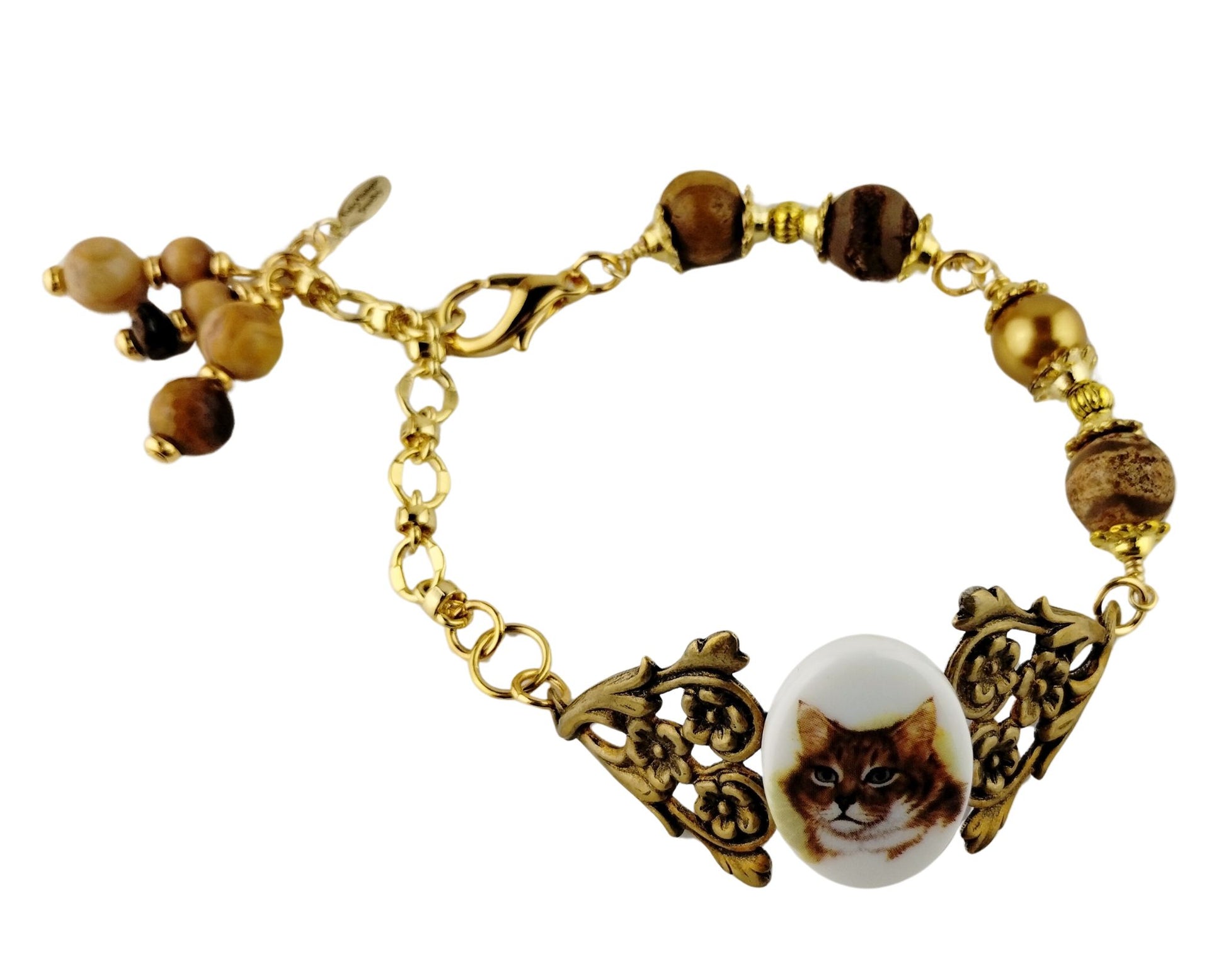 Playful handmade cat bracelet styled on neutral background.
