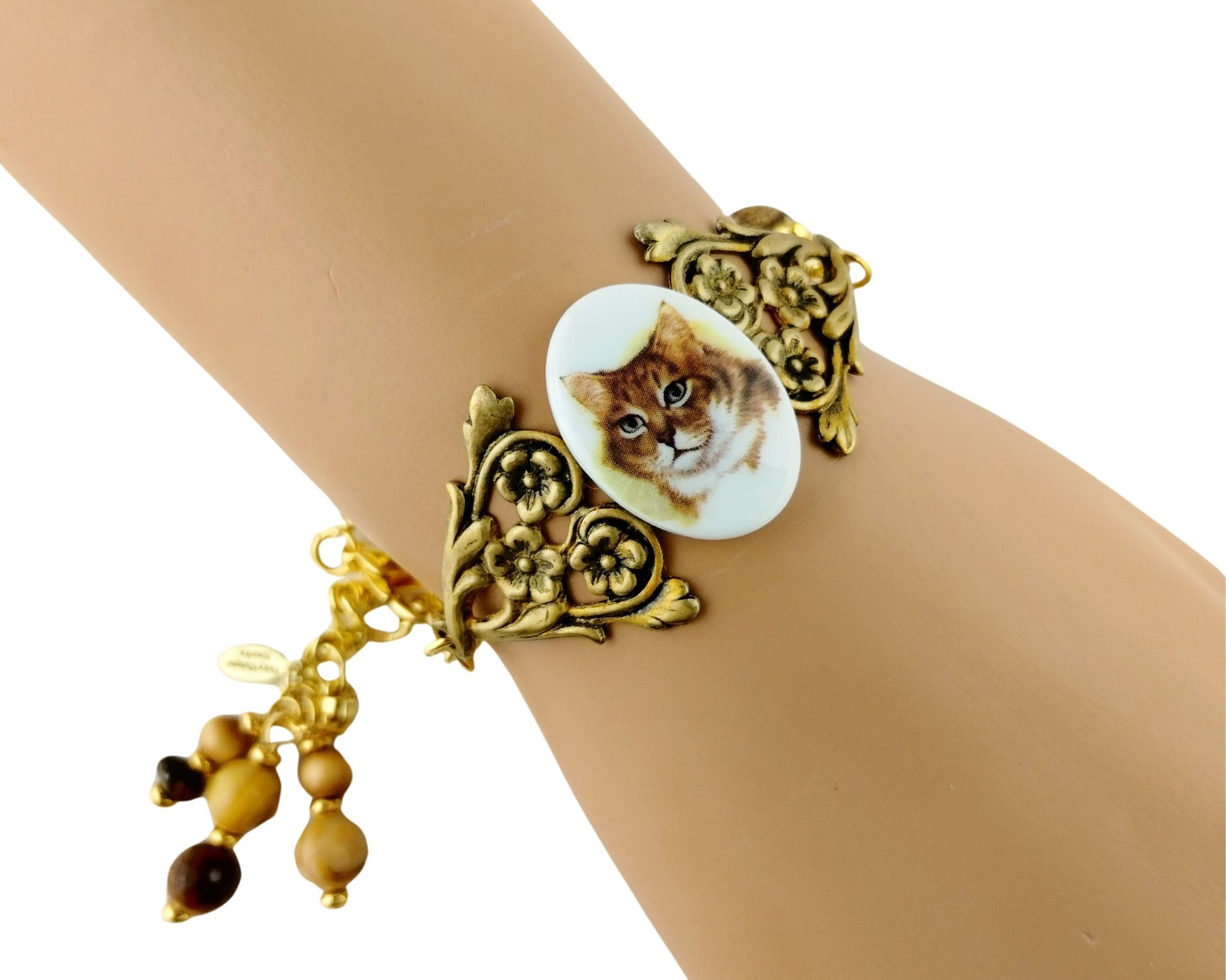 Handmade orange cat bracelet with floral brass centerpiece.