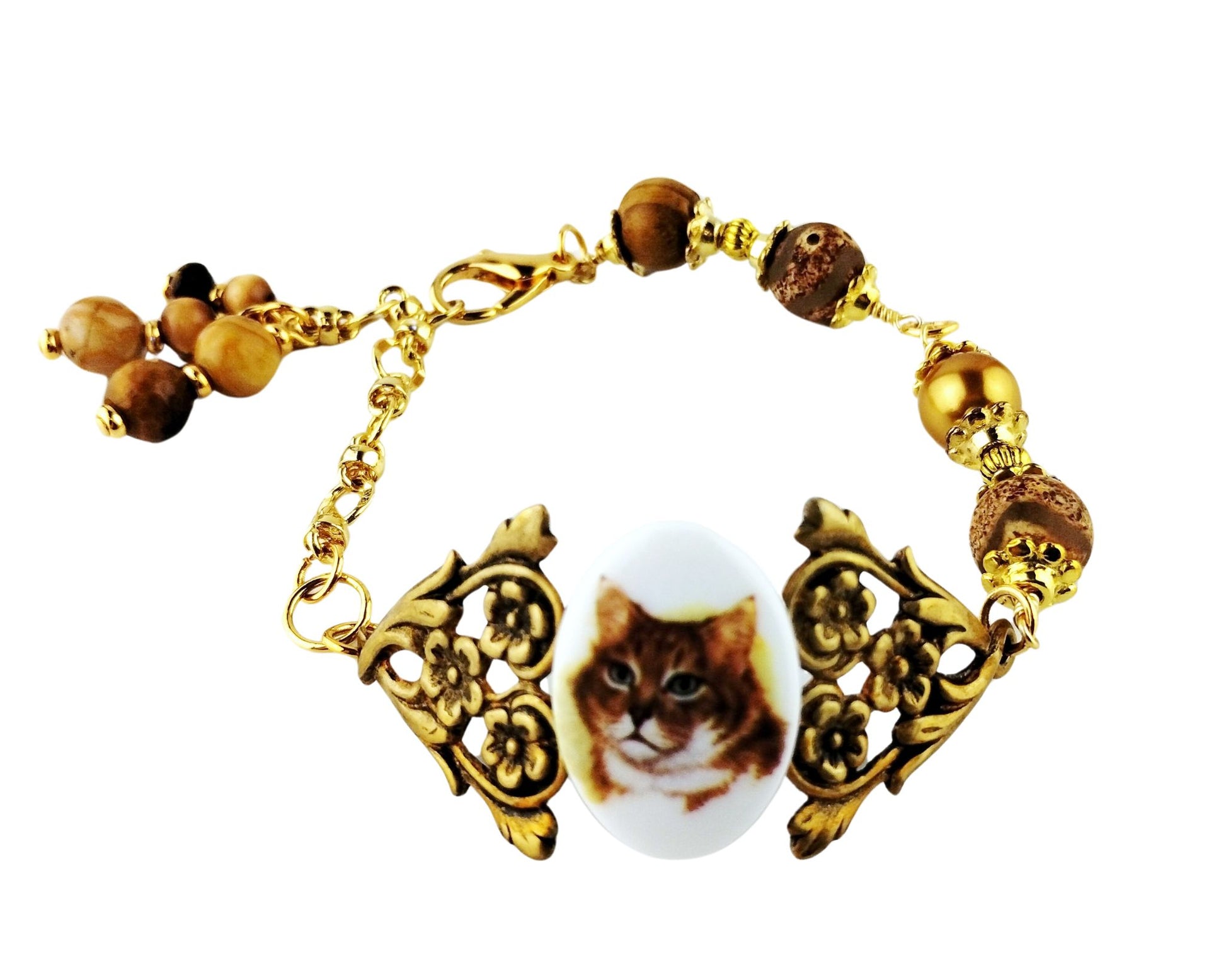 Whimsical cat jewelry featuring floral motif and earthy bead tones.