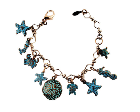 Handmade copper sea creature charm bracelet with ocean-themed design.

