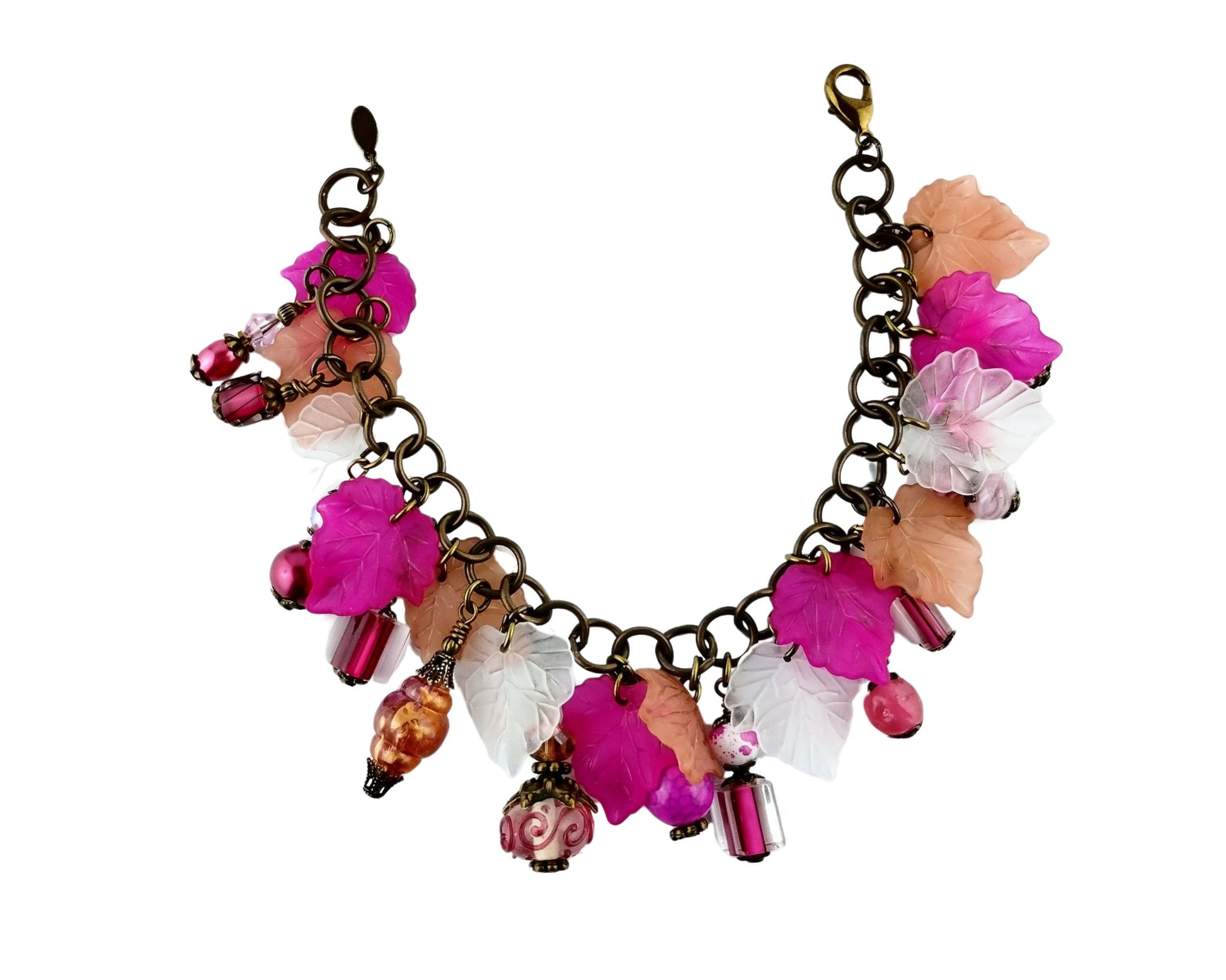 Nature-inspired pink charm bracelet with vintage brass finish