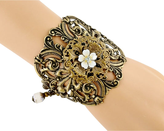 Decorative bracelet with floral design on a wrist against a white background
