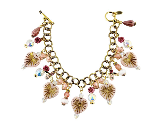 Gold bracelet with various charms on a white background