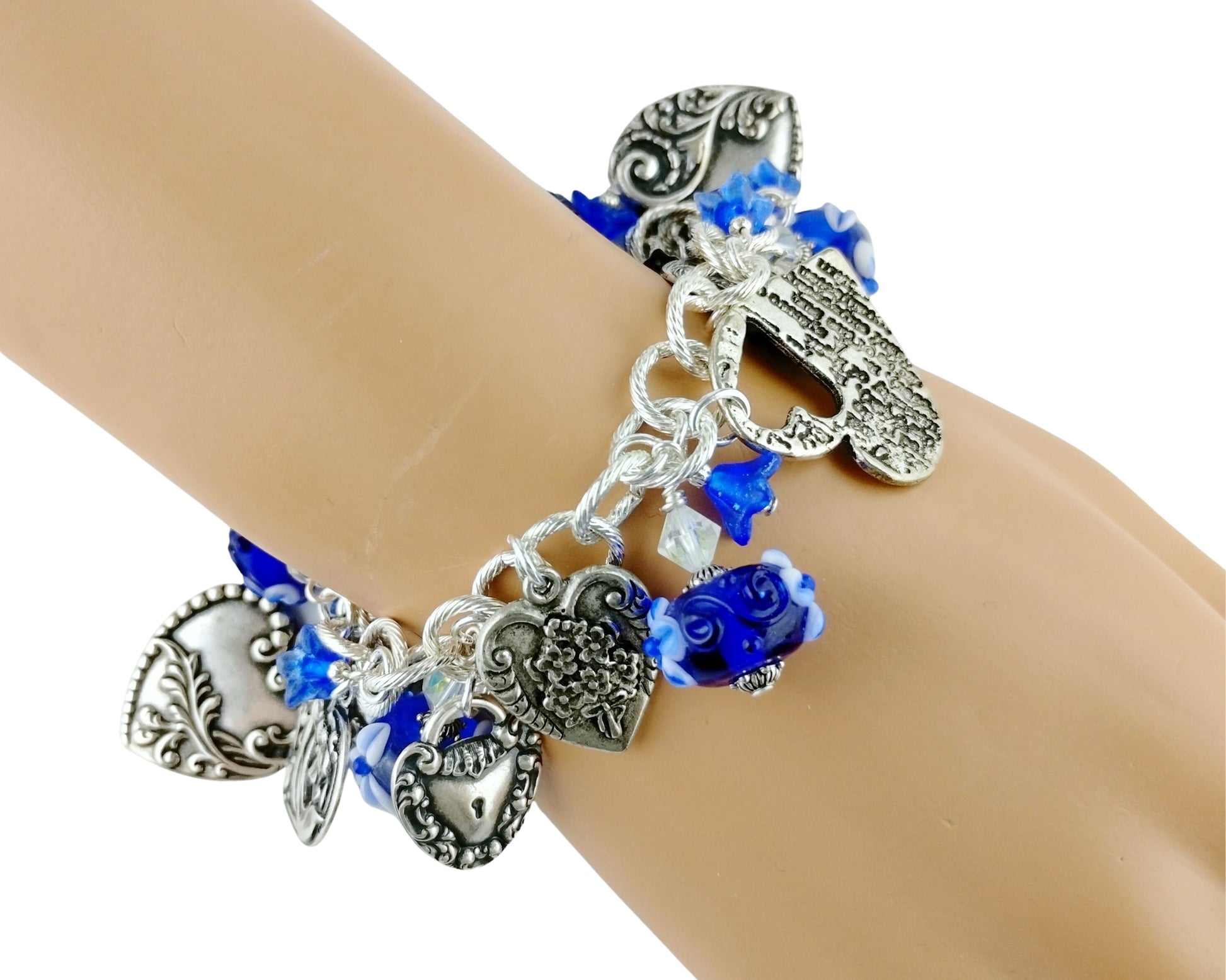 Silver bracelet with heart charms and blue beads on a wrist.