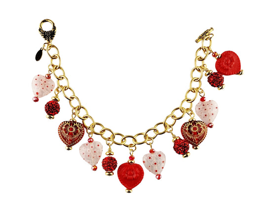 Gold bracelet with red and white heart-shaped charms on a white background