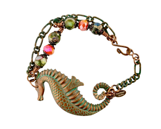 Bracelet with seahorse charm and multicolored beads on a white background