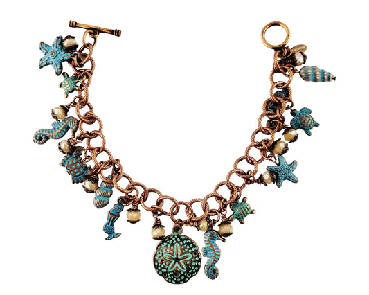 Bracelet with various charms including stars, turtles, and seahorses on a white background