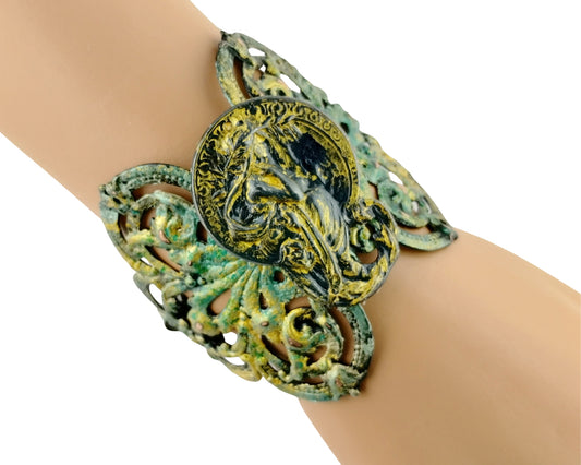Decorative bracelet with intricate design on a wrist against a white background
