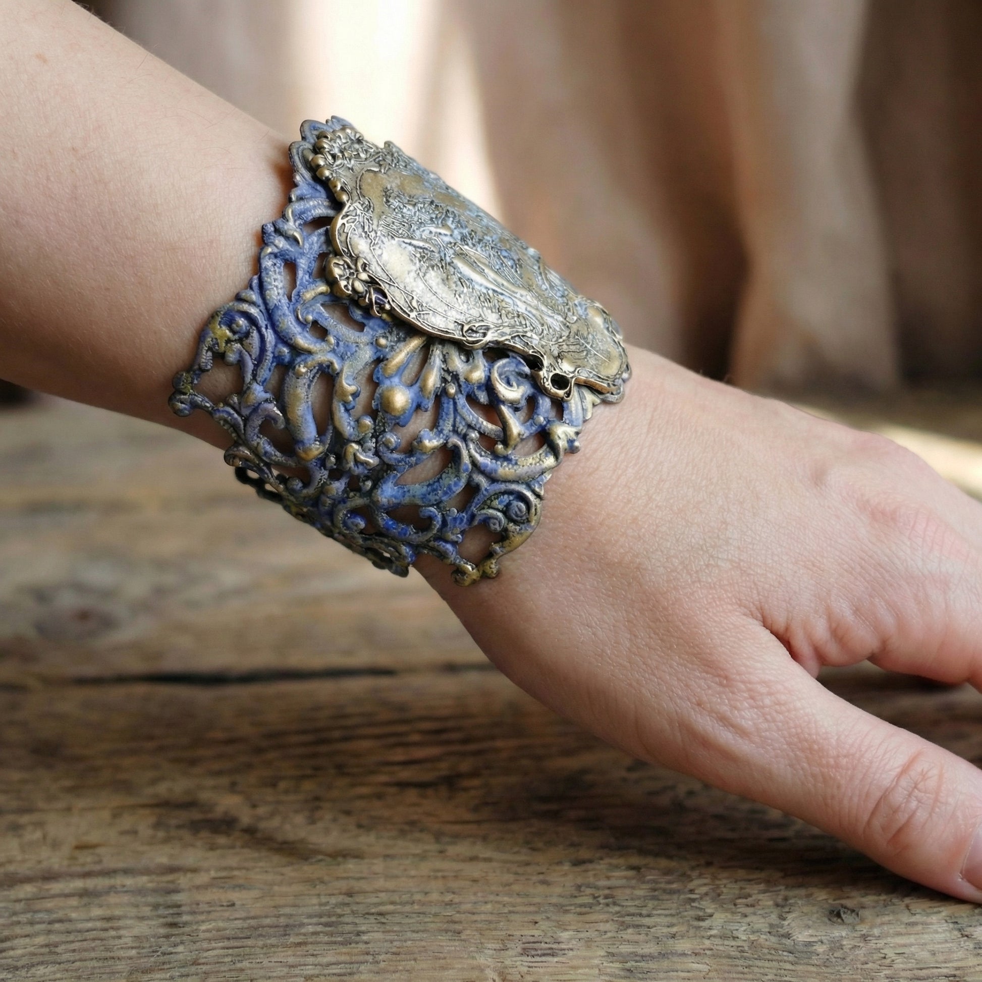 Decorative bracelet on a wrist against a wooden background