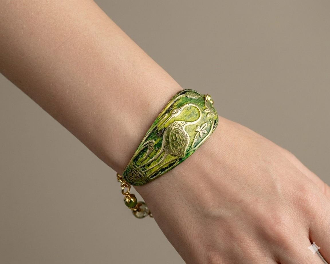 Decorative green and gold bracelet on a wrist against a neutral background