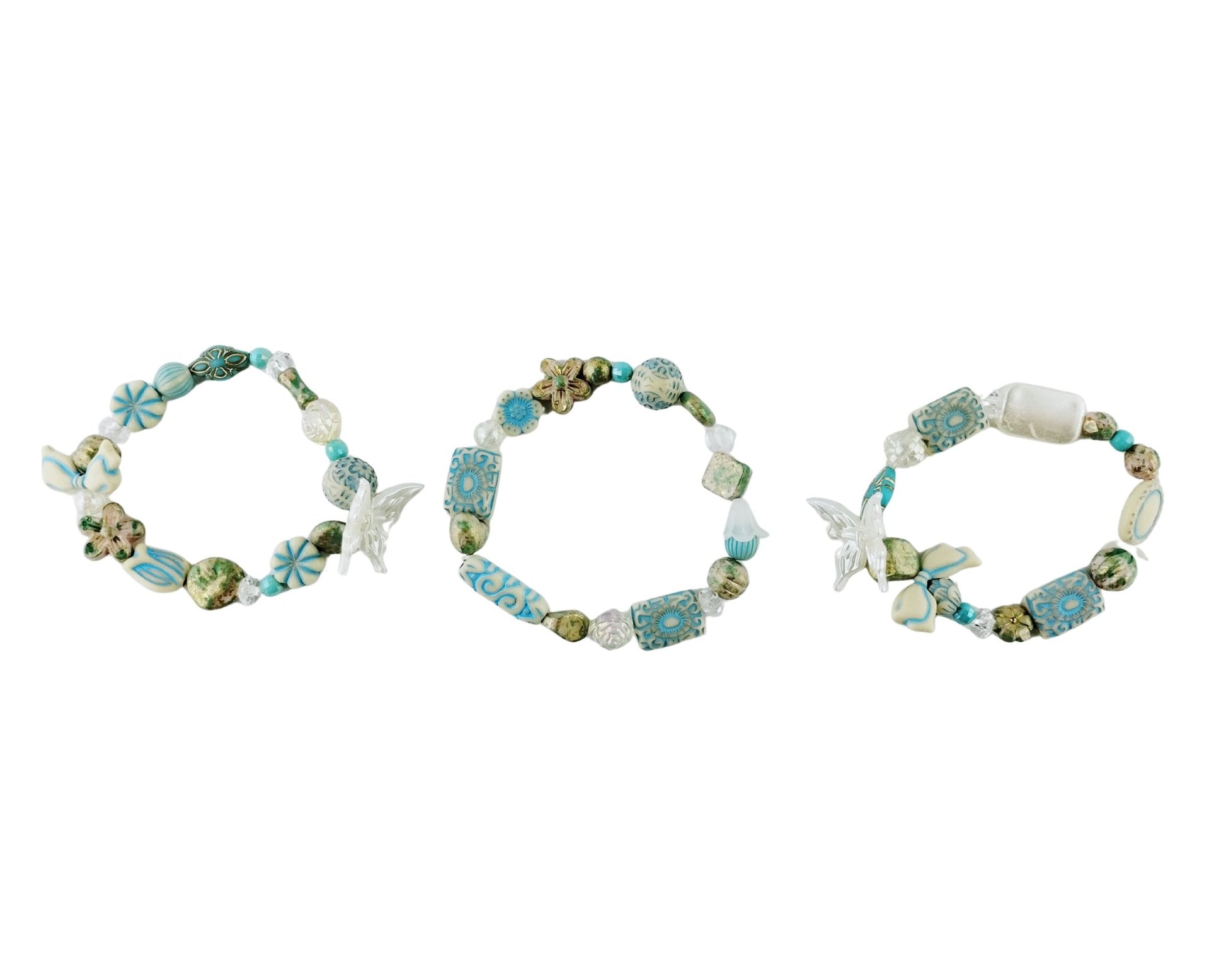 Three beaded bracelets with starfish and shell decorations on a white background