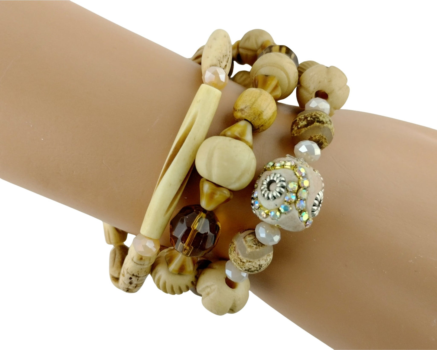 Beaded bracelet with natural and metallic elements on a wrist against a white background