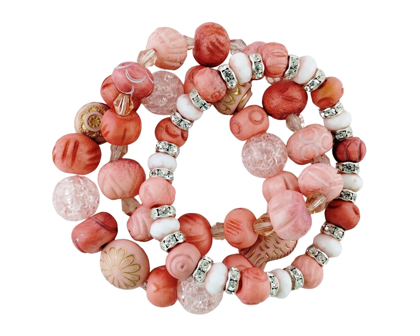 A set of three beaded stretch bracelets featuring pink, coral, and white beads with silver rhinestone accents, displayed on a clean white background.