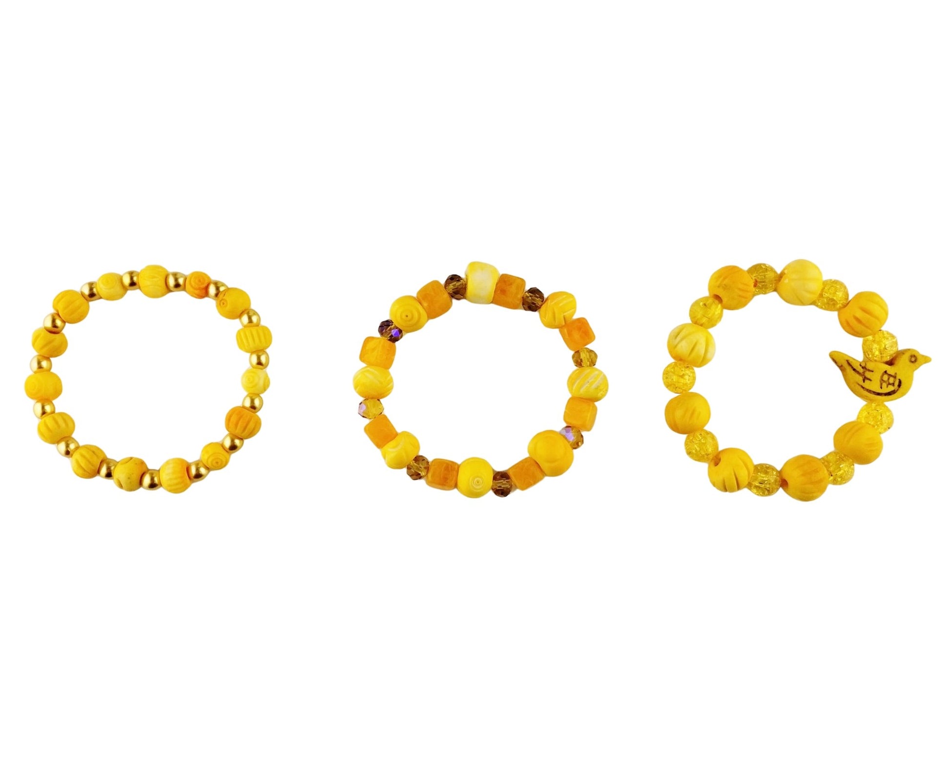 Three yellow beaded bracelets arranged horizontally on a plain white background. The left bracelet has round yellow beads with yellow glass pear spacer beads.