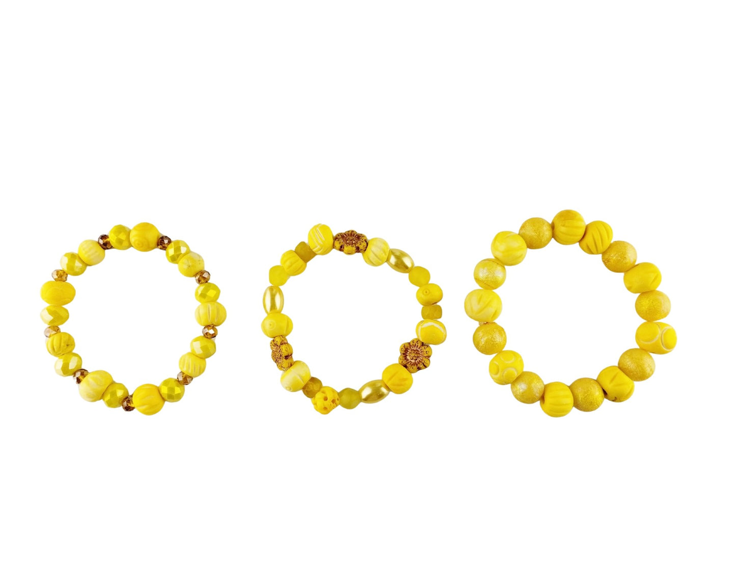 Three yellow beaded stretch bracelets arranged side by side on a plain white background.
