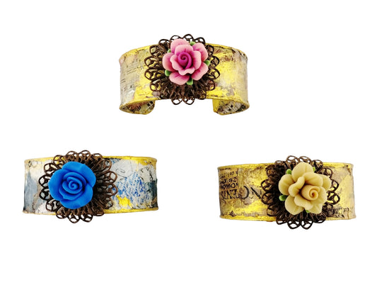Decoupaged Bracelets with matching flower on white backgroud.