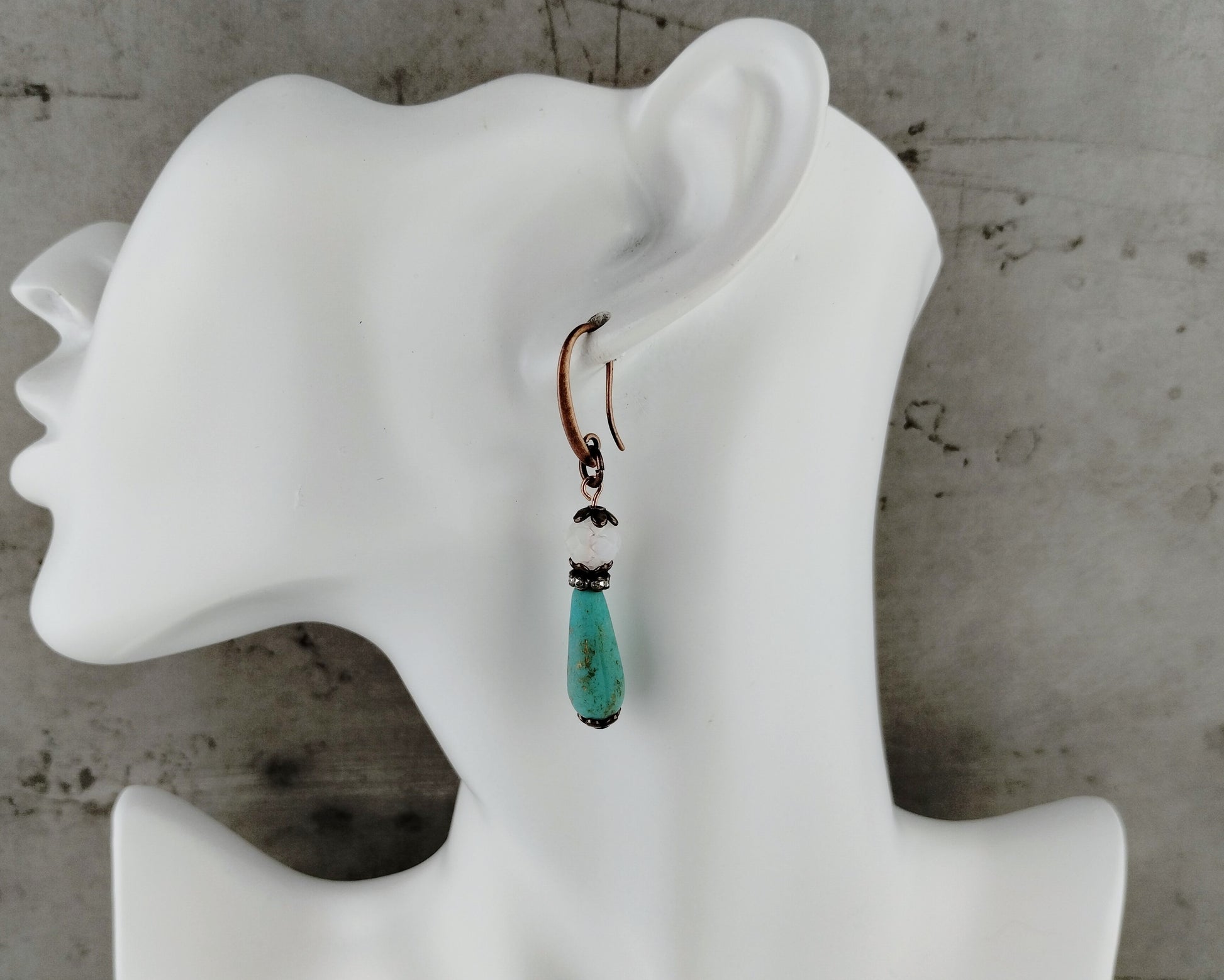 Frosted white and blue beaded earrings with copper accents.
