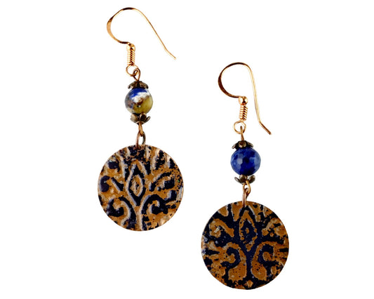 Hand-painted navy blue round copper earrings on neutral display