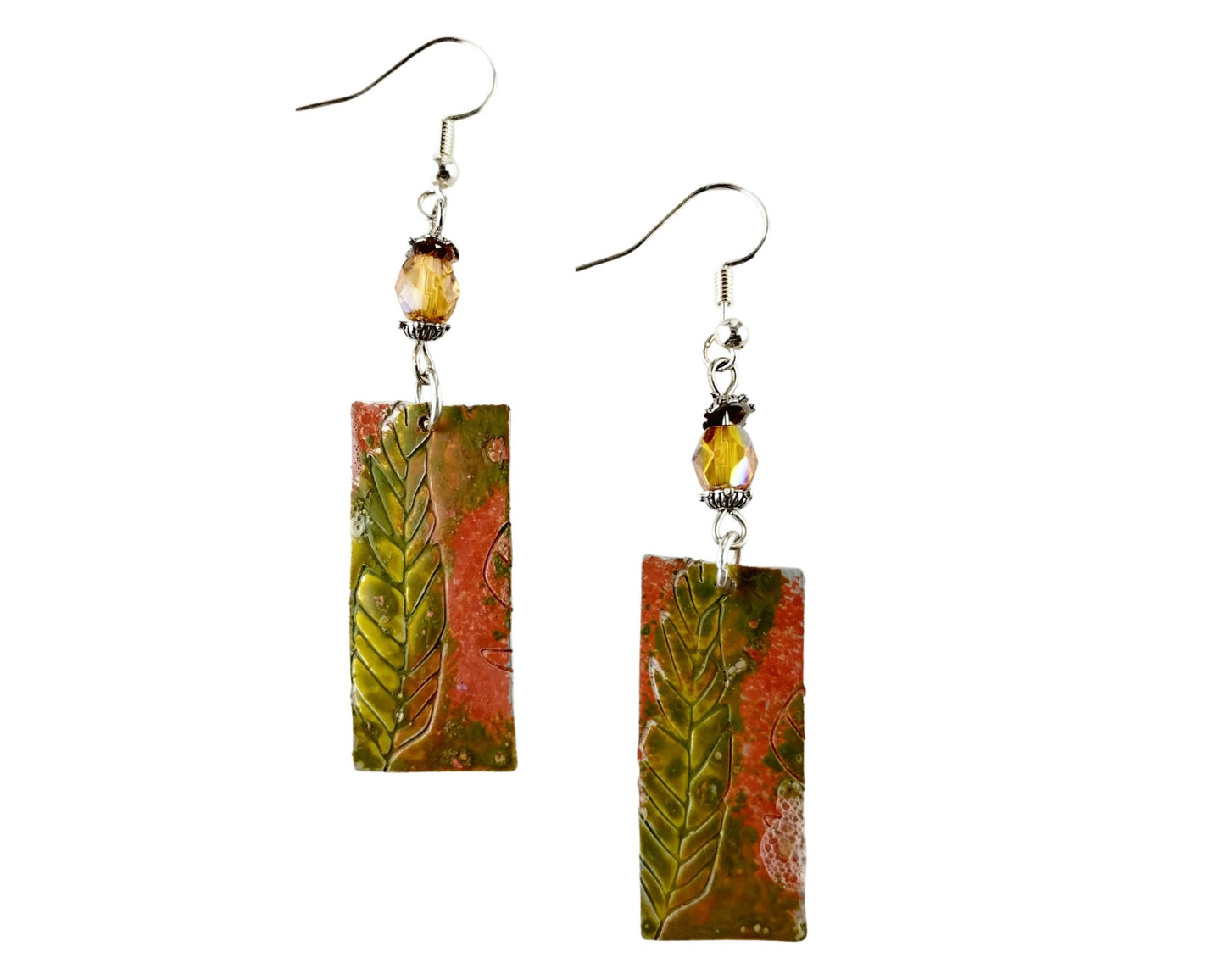 Hand-painted pewter fern earrings with amber pink glass beads on white background
