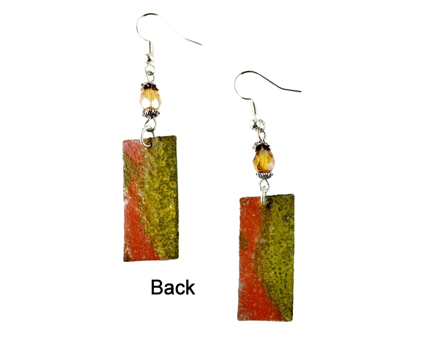 Back of botanical pewter fern design earrings with earthy tones