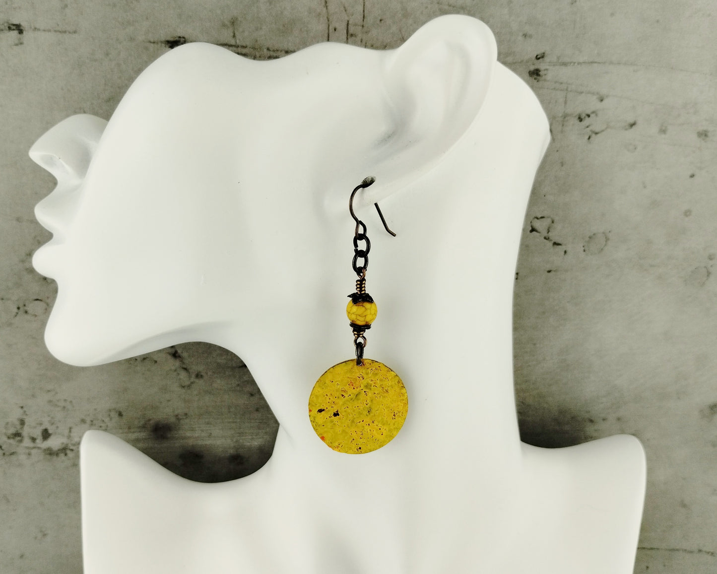 Artisan-crafted yellow brass earrings featuring golden glass beads.