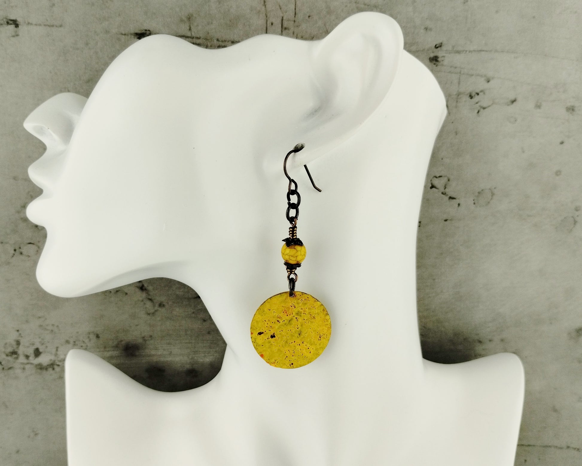 Artisan-crafted yellow brass earrings featuring golden glass beads.