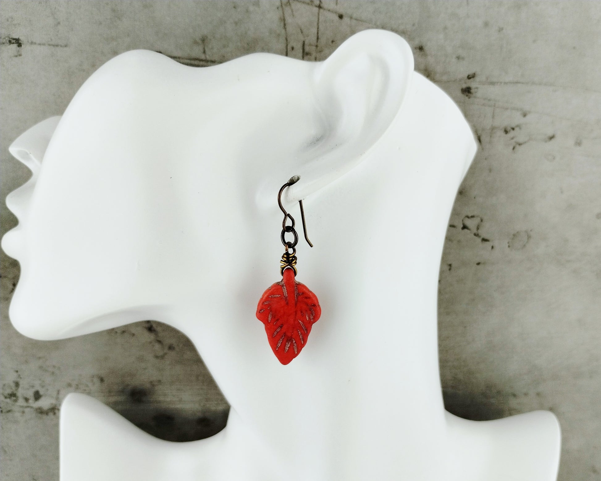 Showcasing the lightweight design and carved gemstone leaves of the earrings.