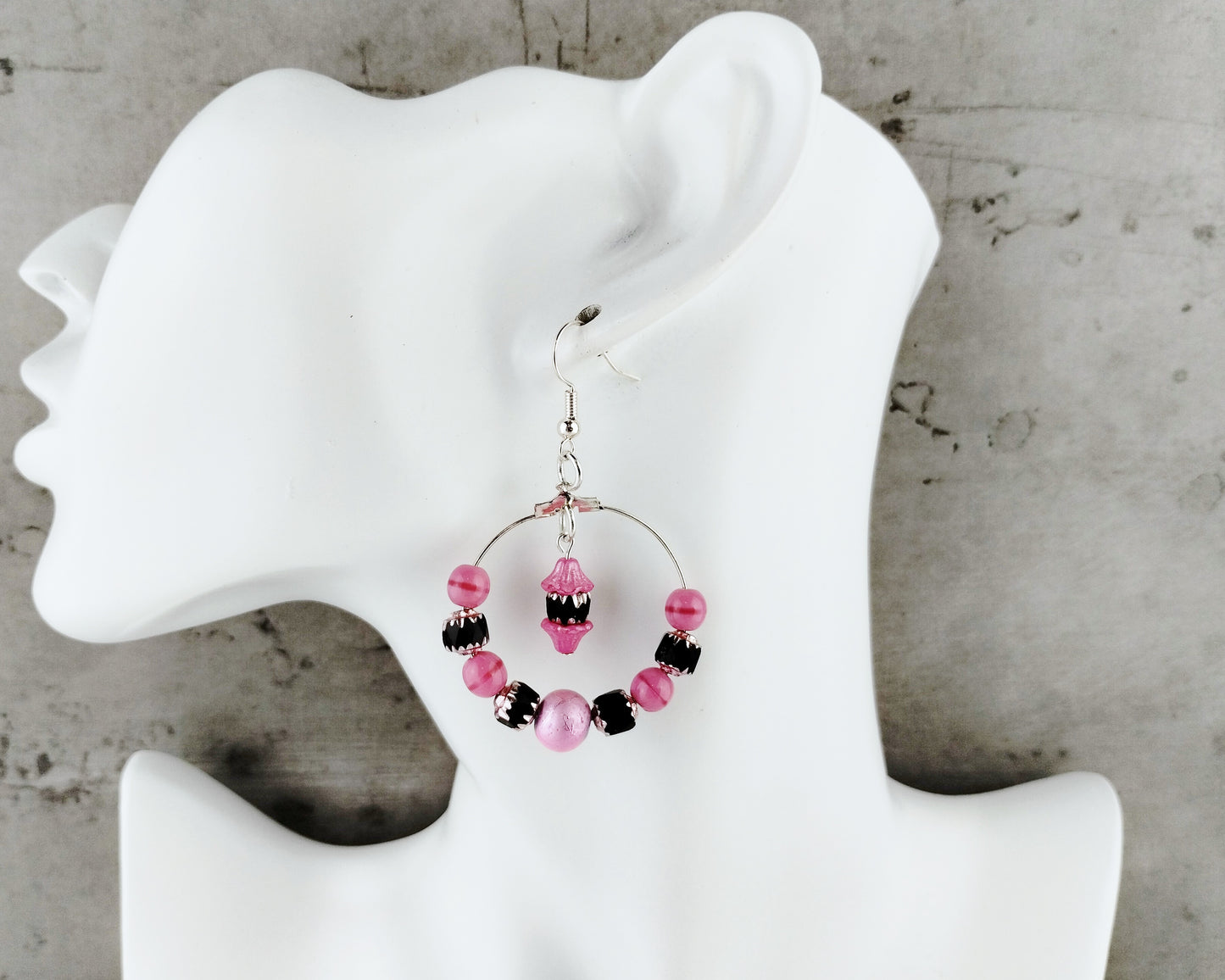 Lightweight pink and black cathedral bead hoop earrings with hypoallergenic ear wires.