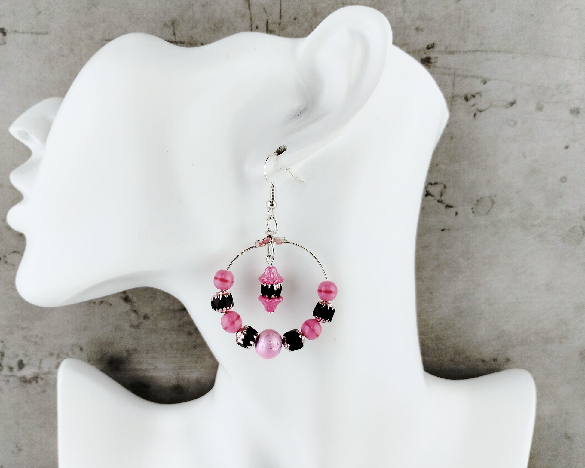 Lightweight pink and black cathedral bead hoop earrings with hypoallergenic ear wires.