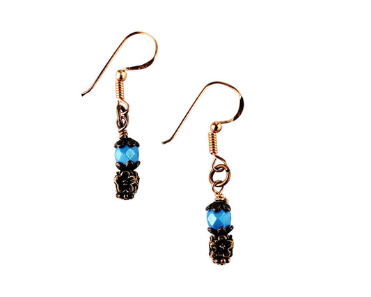 Handmade steel blue and copper earrings with vintage-style floral bead accents.