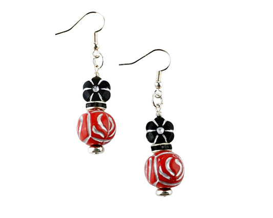 Handmade earrings with black flower bead and red acrylic drop
