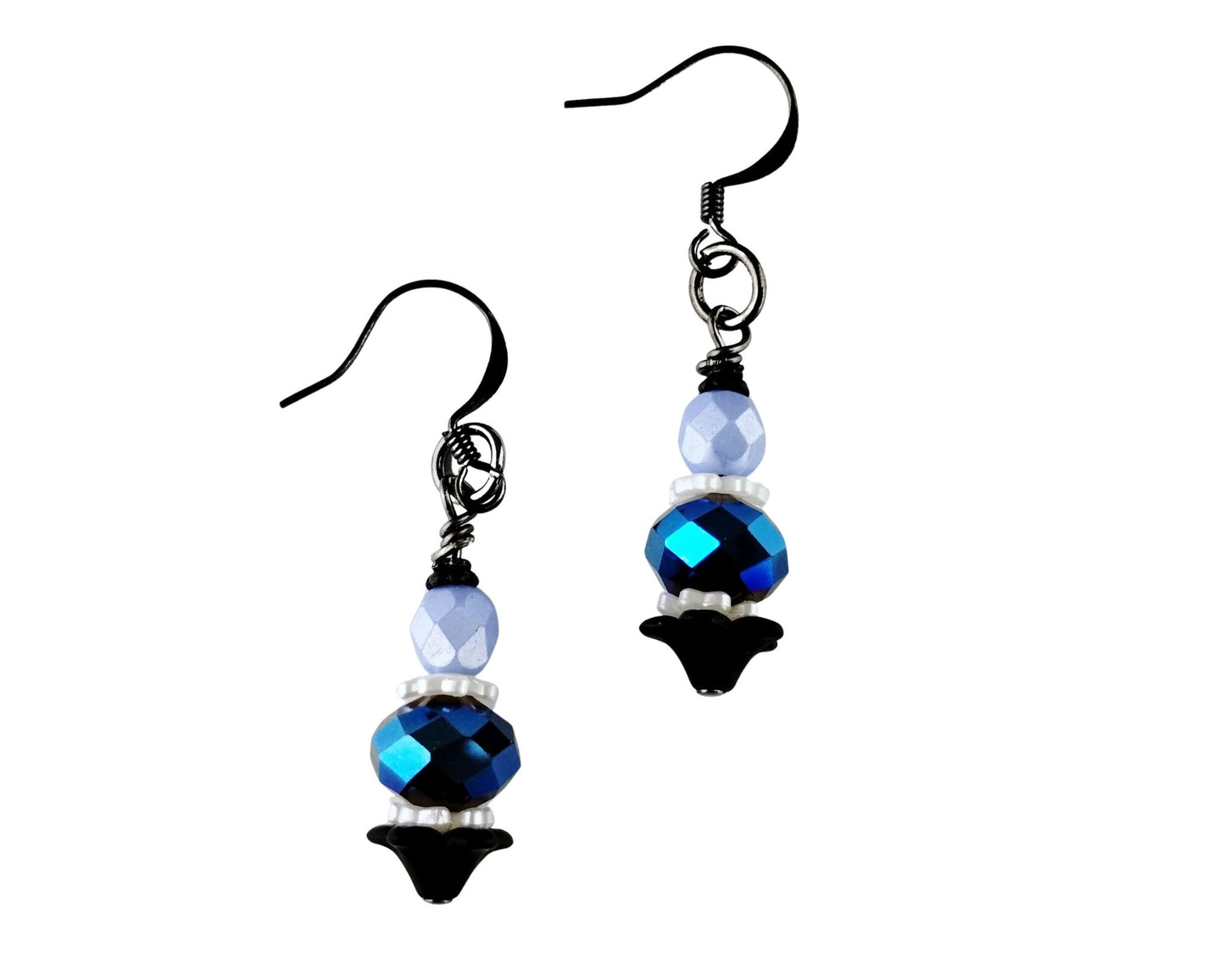 Pair of earrings with blue and black beads on a white background