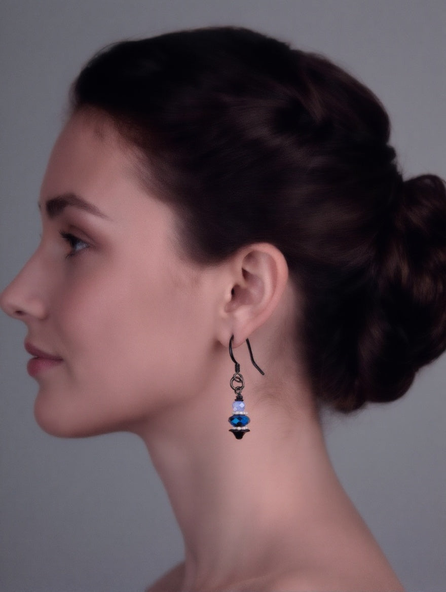 Woman wearing earrings with a gray background