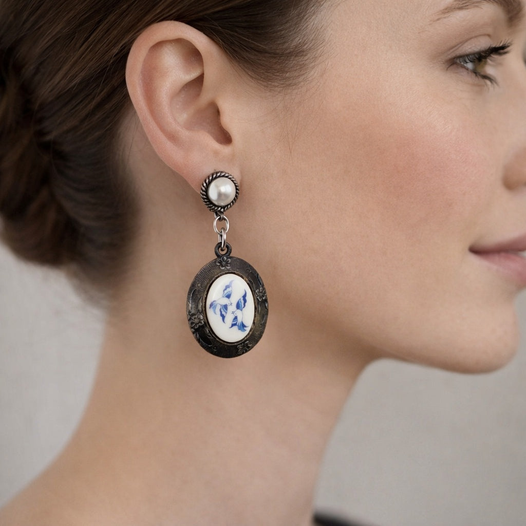 Close-up of a woman wearing an ornate earring with a floral design.