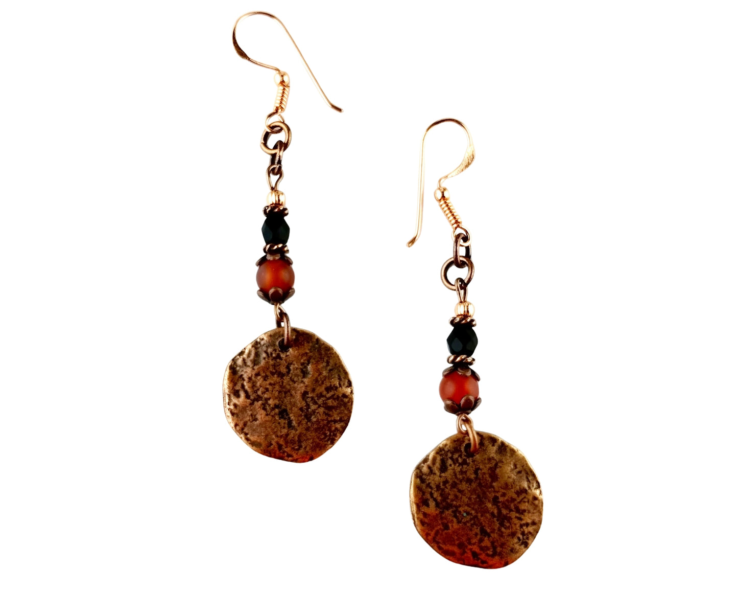 Pair of earrings with round metallic discs and orange beads on a white background