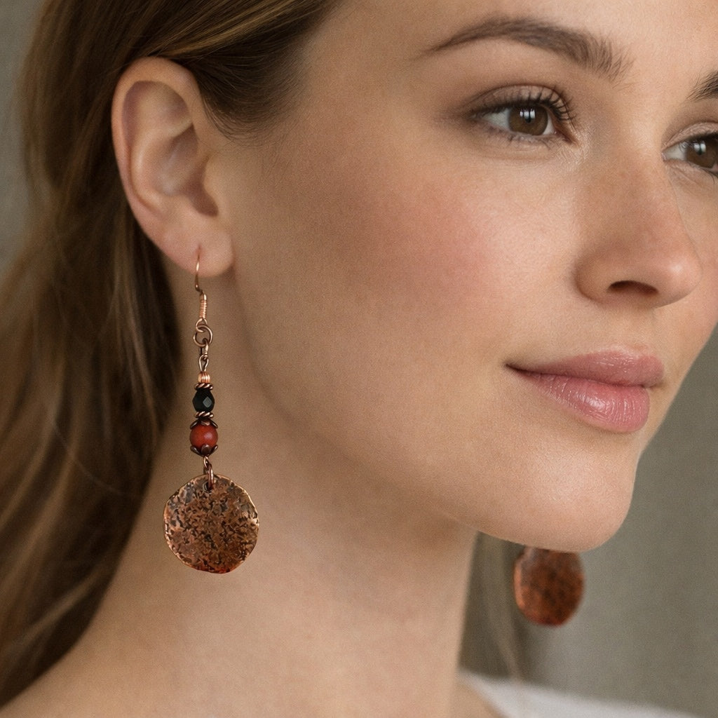 Close-up of a woman wearing a pair of earrings with a neutral background