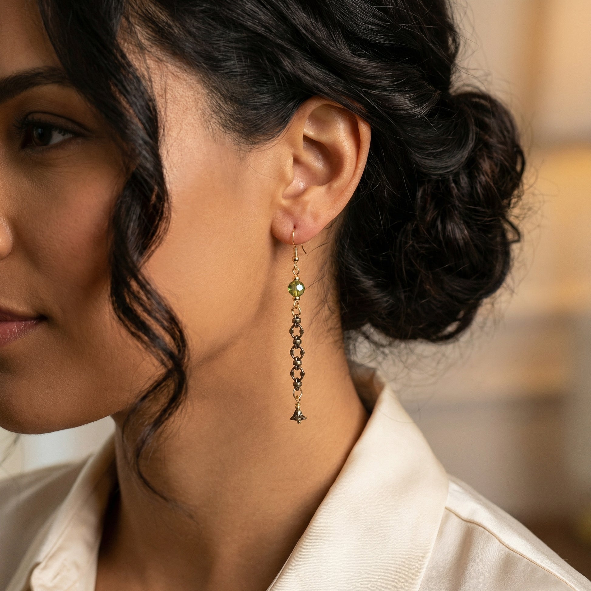 Close-up of a woman wearing a dangling earring with a blurred background