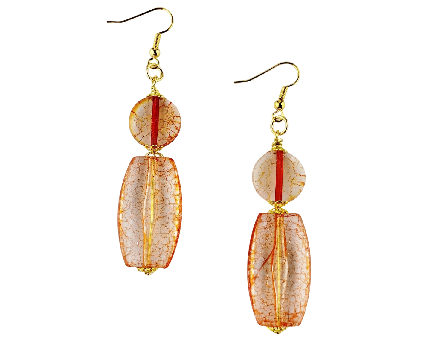 Pair of earrings with orange and gold design on a white background