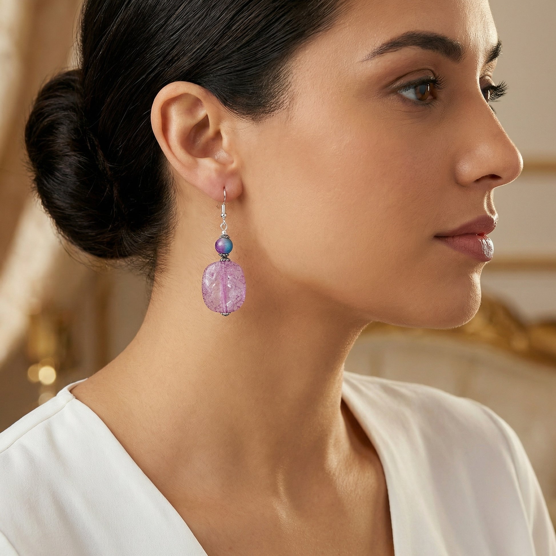 Close-up of a woman wearing a purple earring with a blurred background