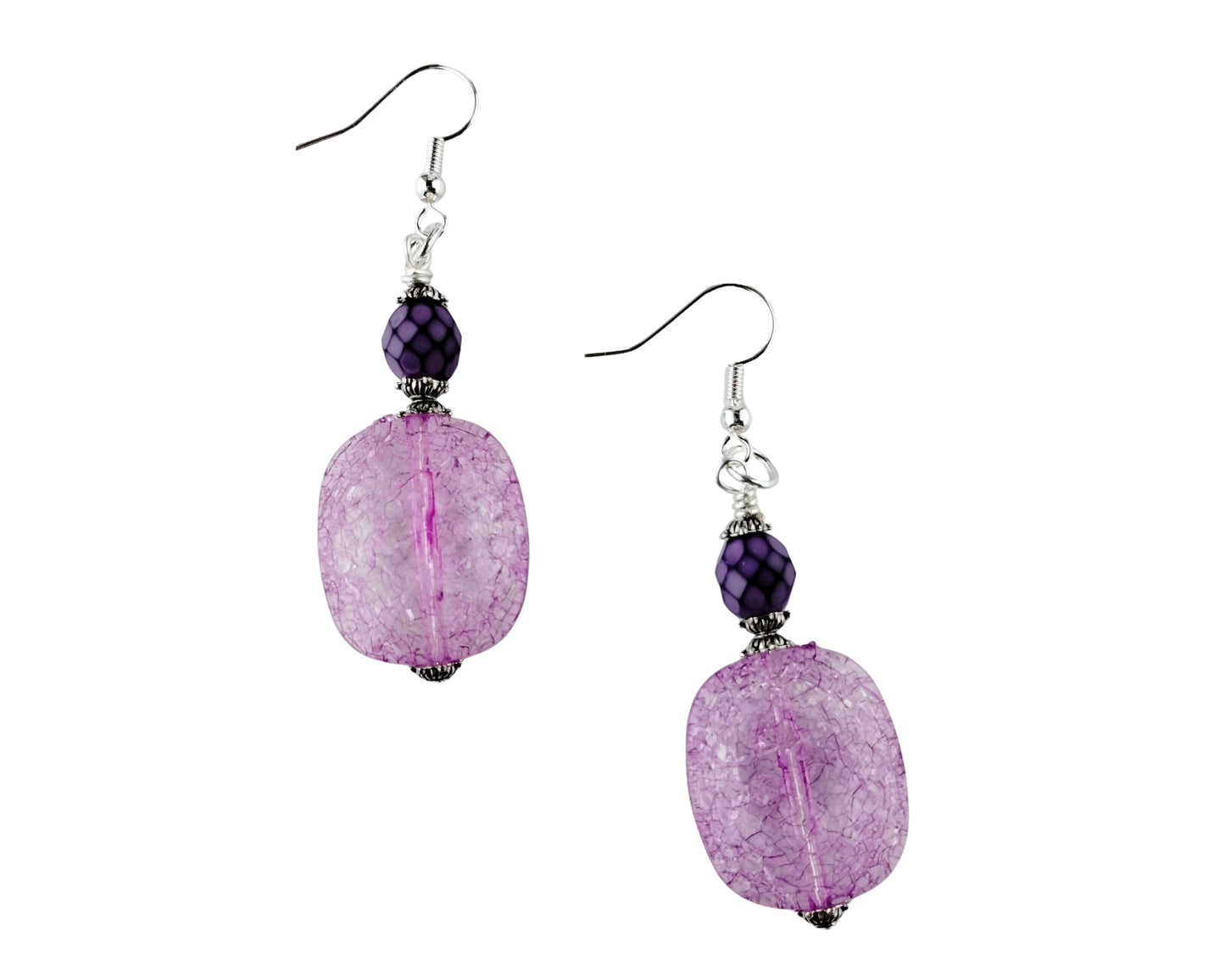 Pair of earrings with purple beads on a white background