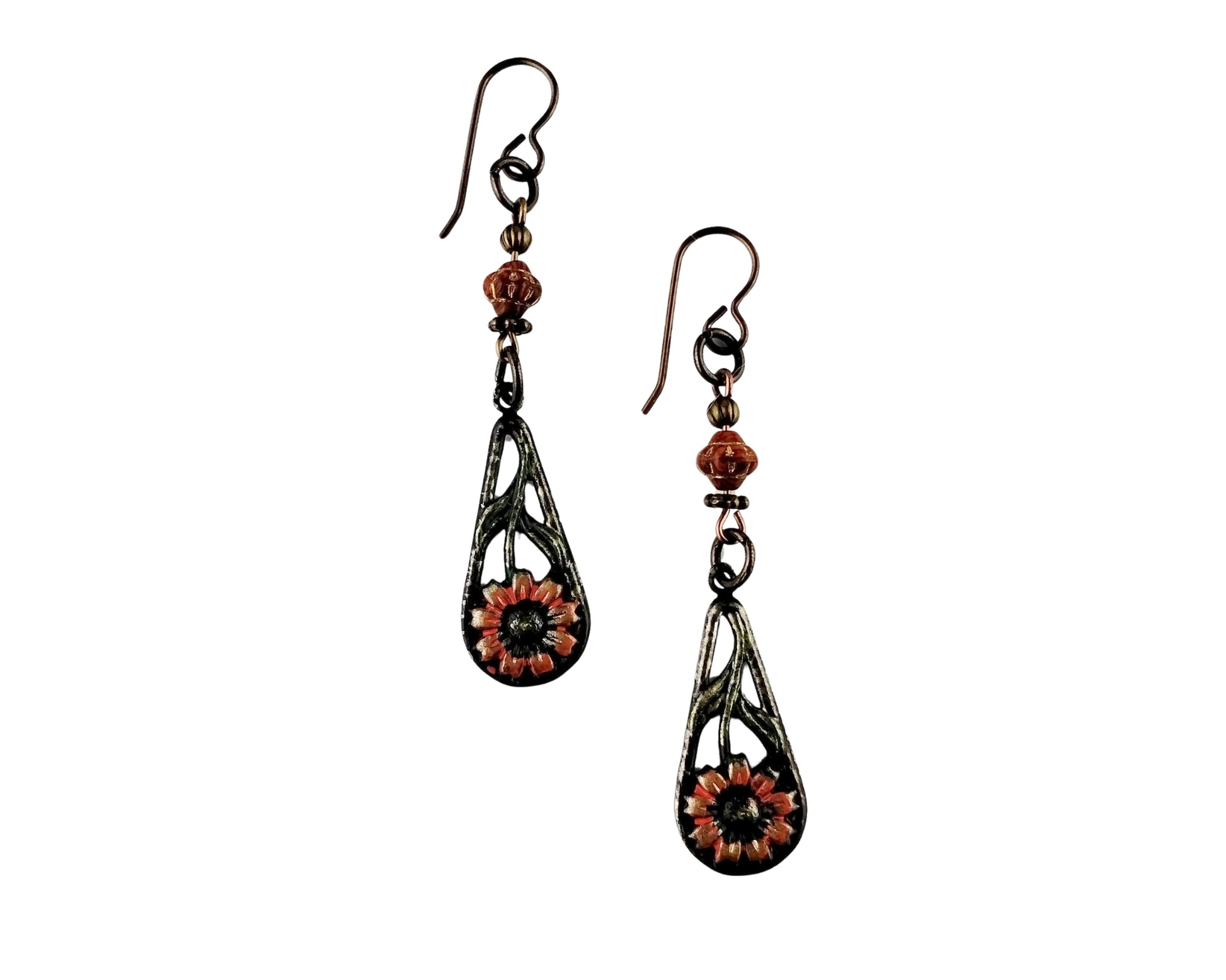 Pair of earrings with floral designs on a white background