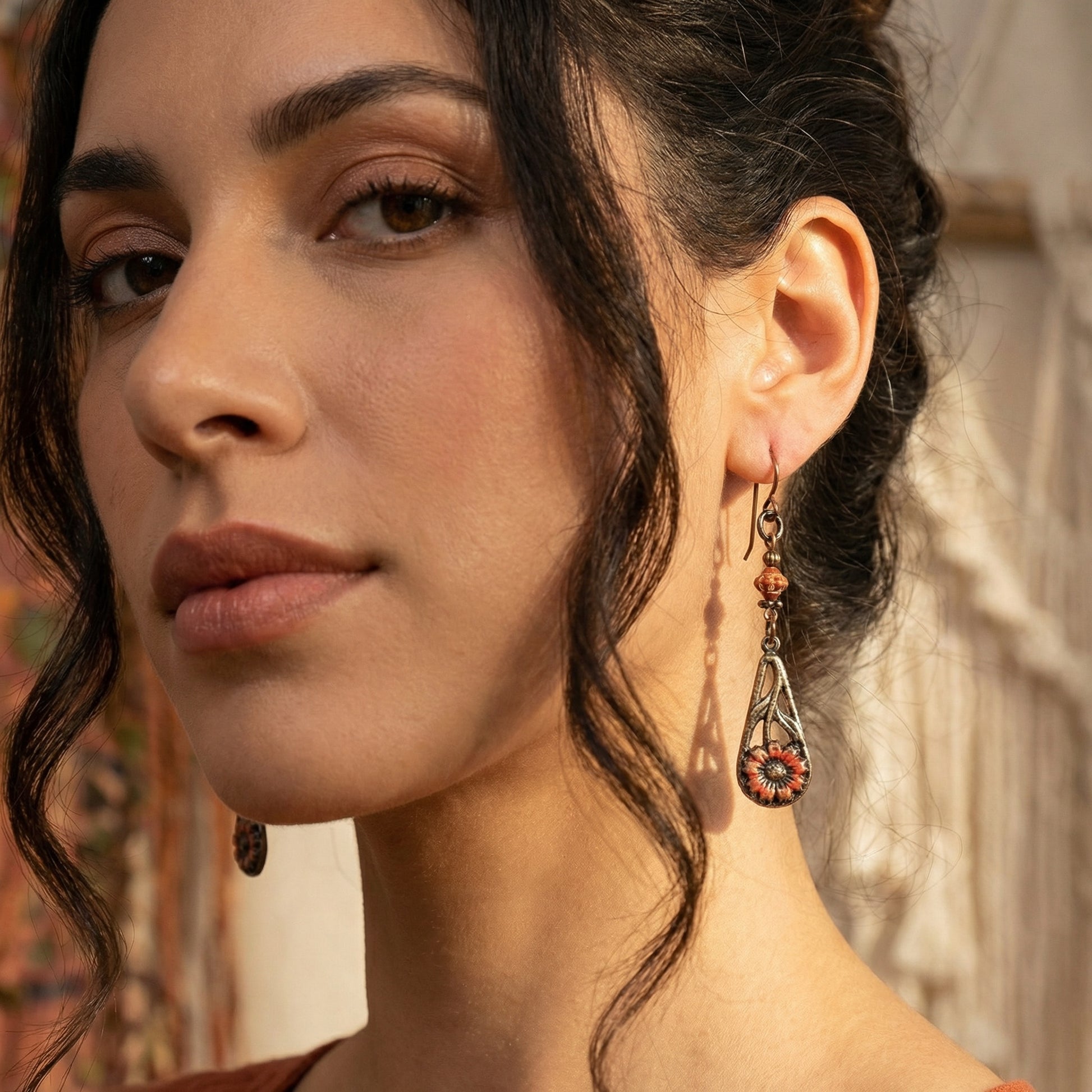 Close-up of a woman wearing earrings with a blurred background