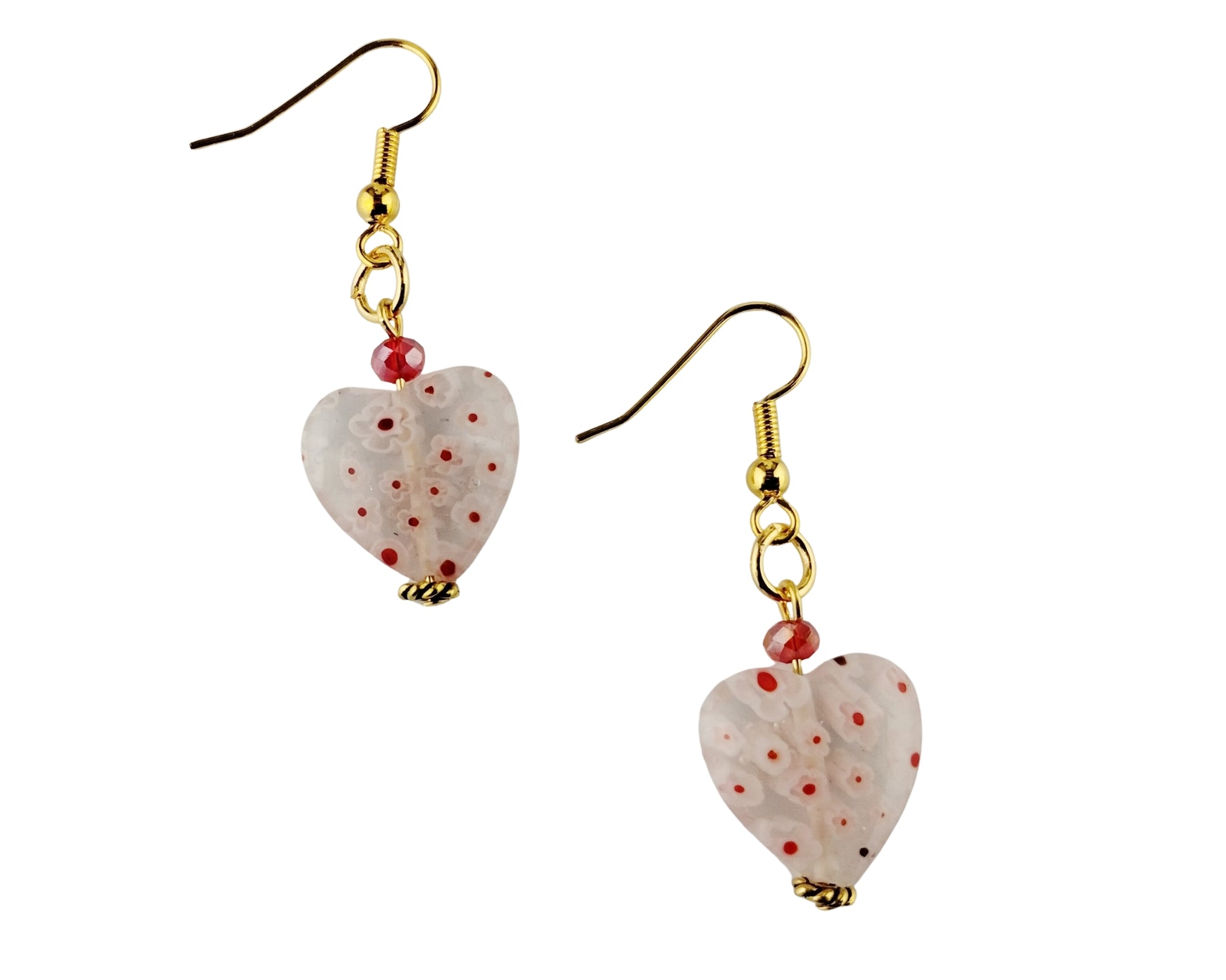 Heart-shaped earrings with gold hooks and red speckles on a white background