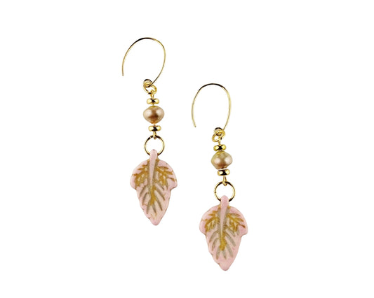 Pair of earrings with pink leaf-shaped charms on a white background