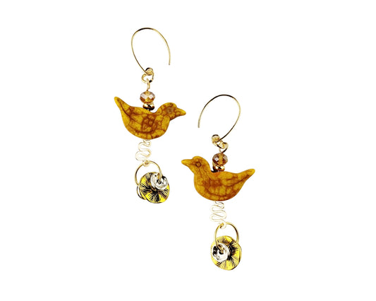 Pair of earrings with bird designs on a white background