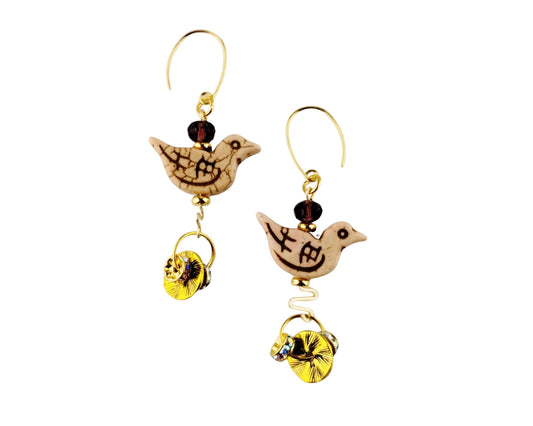 Pair of bird-shaped earrings with gold accents on a white background