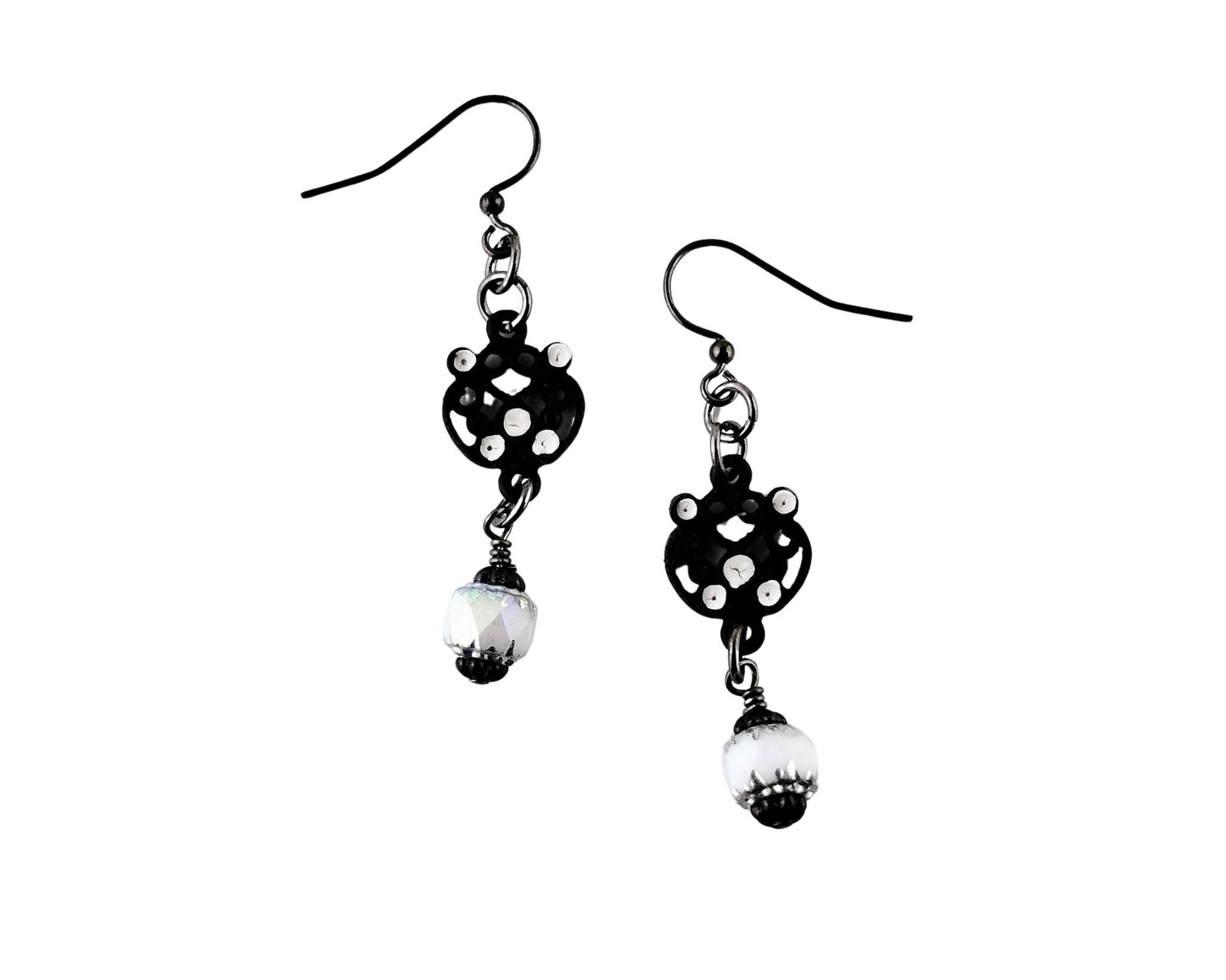 Black and white polka dot earrings with pearl-like beads on a white background