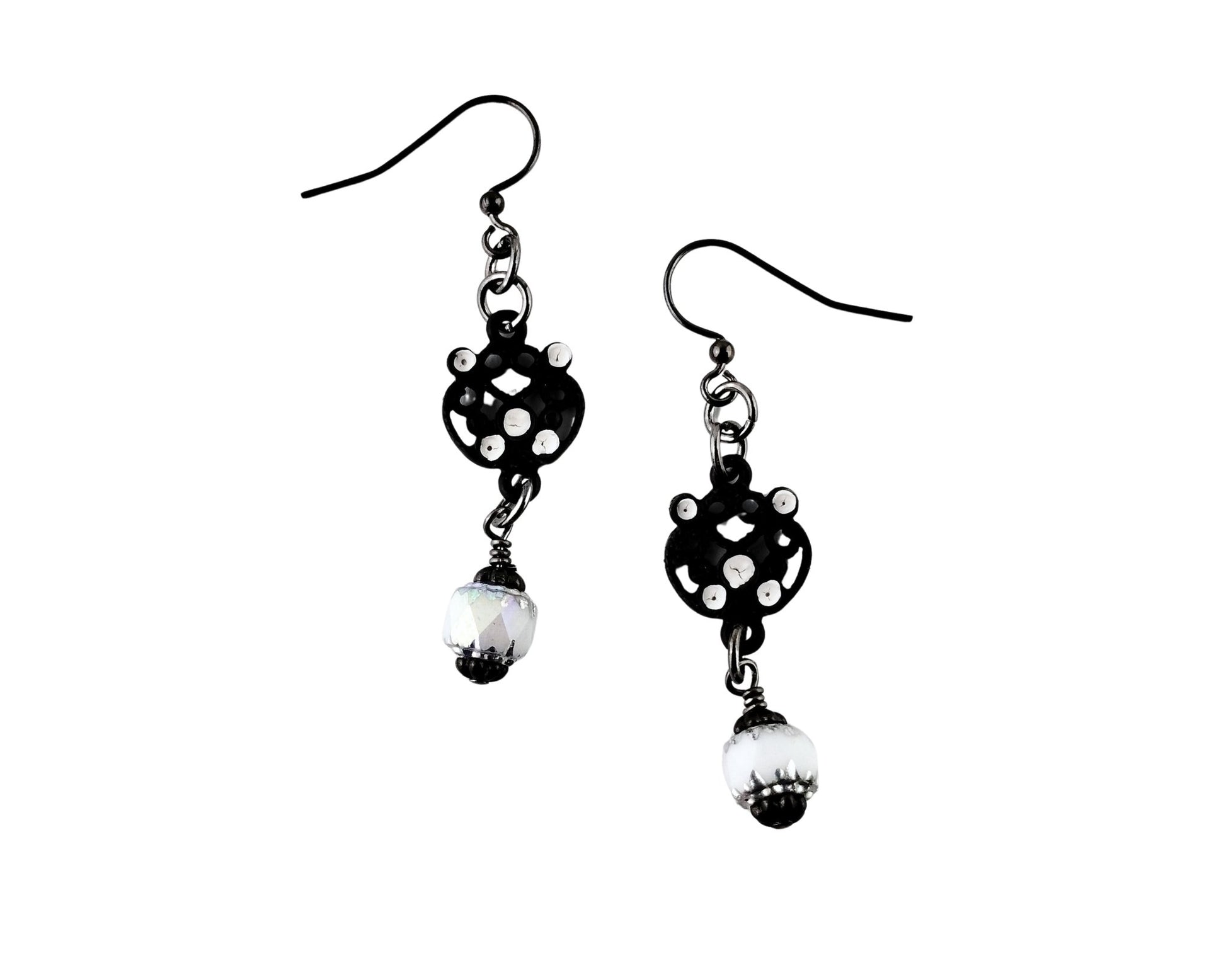 Black and white polka dot earrings with pearl-like beads on a white background